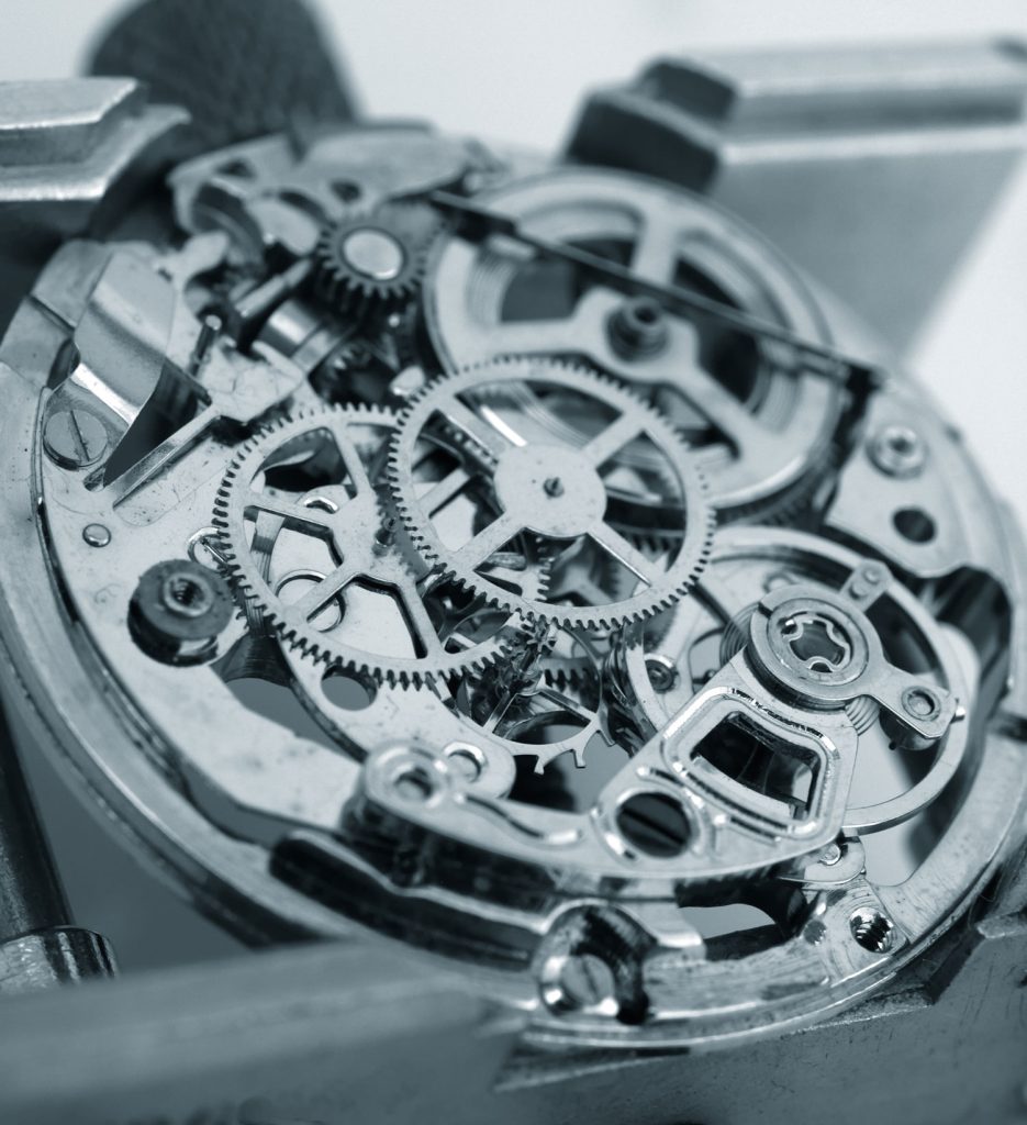 Black-and-white close-up of the wheels and bridges of an open mechanical movement