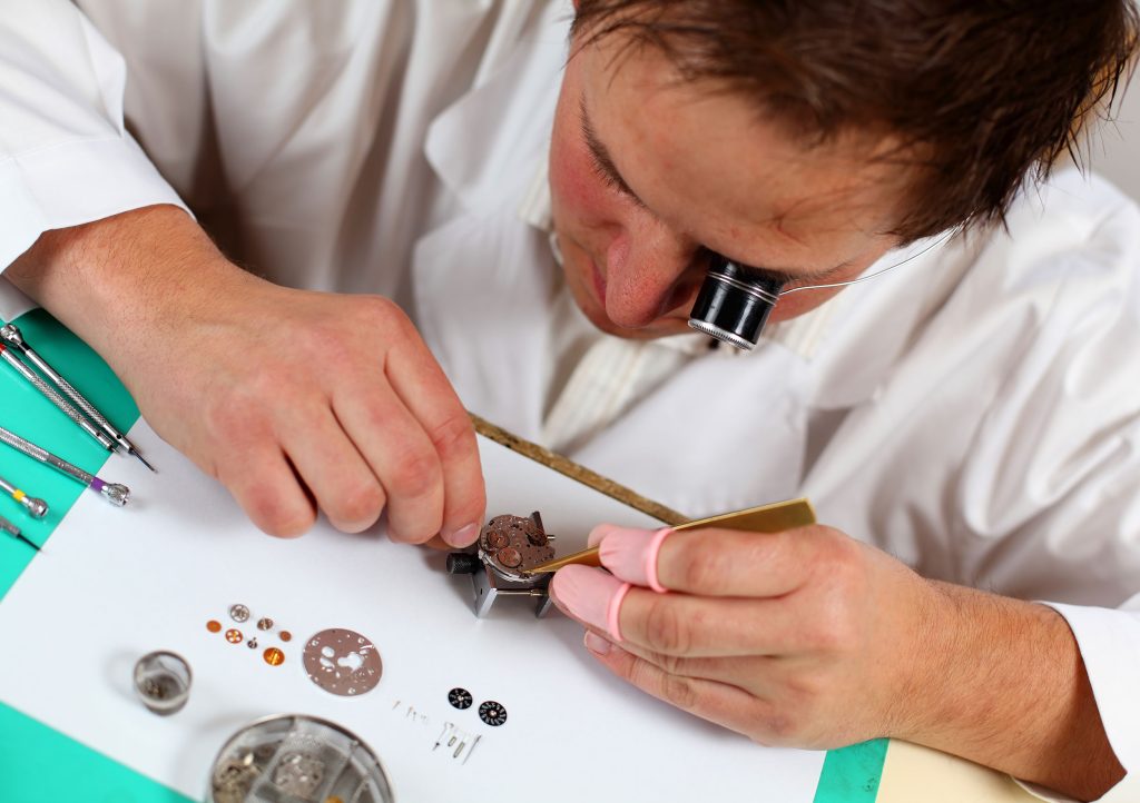 Close-up of a watchmaker at work at the bench